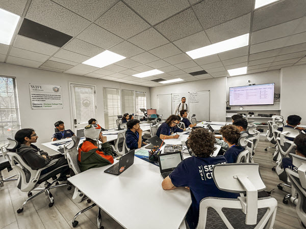 Students in tutoring session listening to tutor Aydin Mehrage.